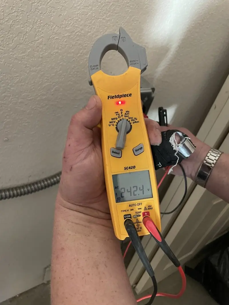 Voltage testing with clamp meter during Ceiling Fan Installation in Harrison